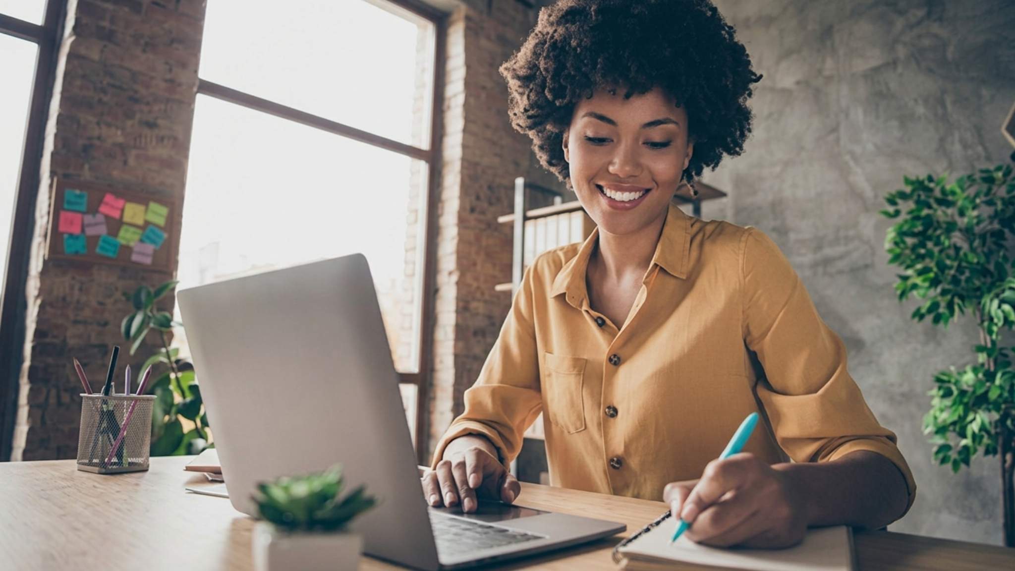 An online English teacher taking notes on her notebook