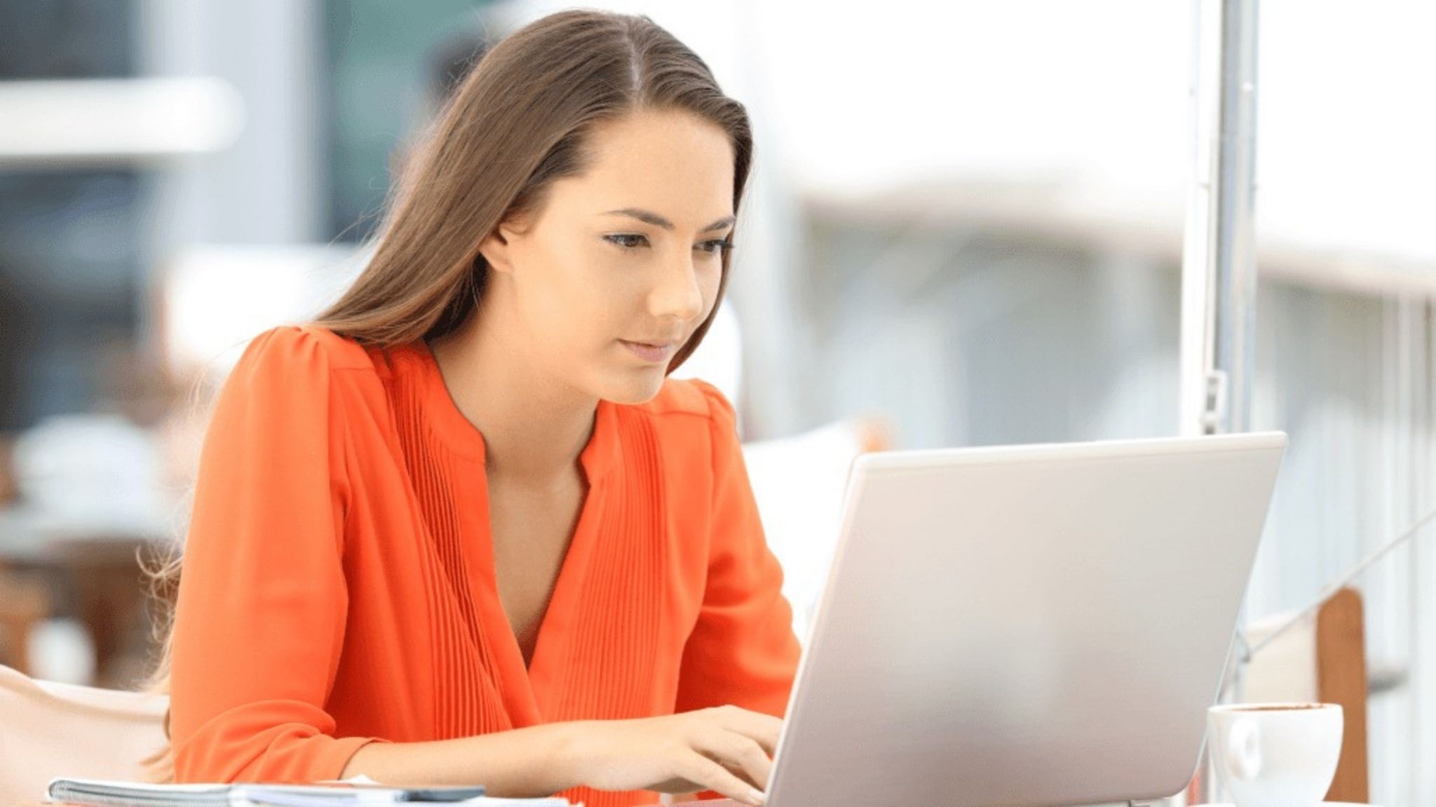 A woman on her leptop looking for legitimate TEFL courses