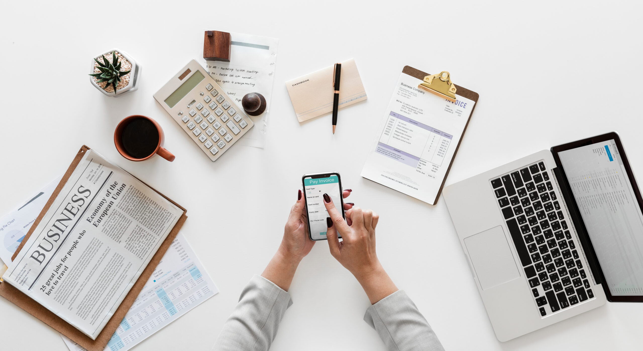 computer, paper and phone on desk