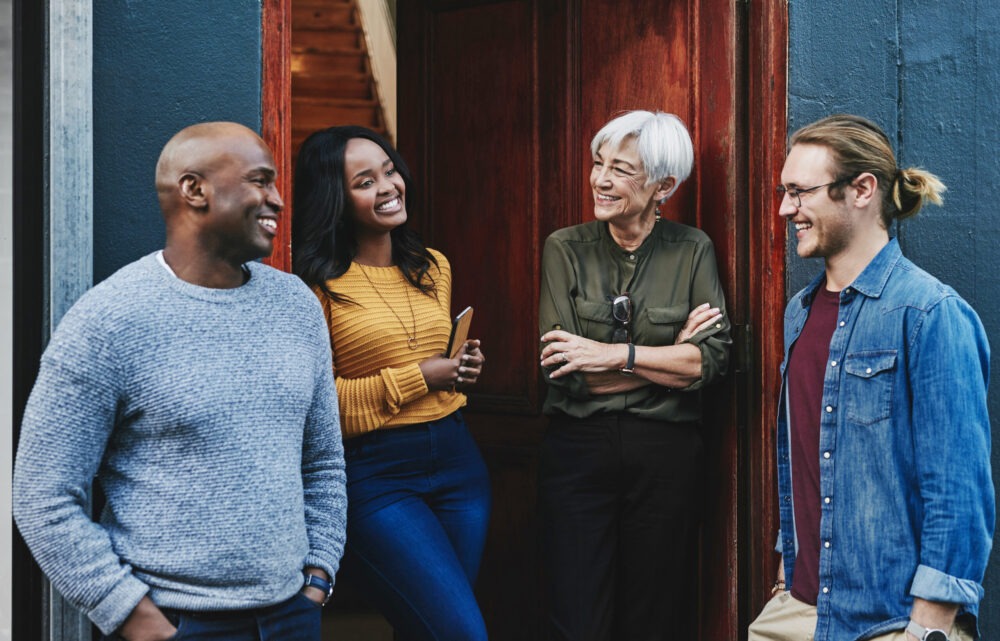 four people standing outside of a people talking