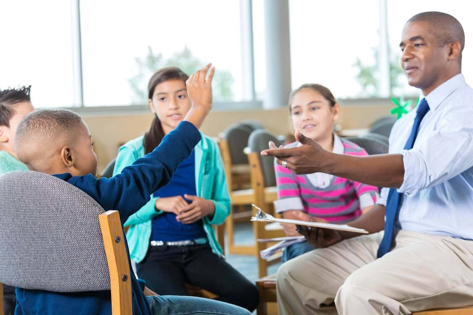 Children learning in a classroom with their teacher