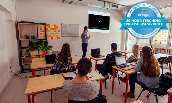 Teacher showing a video to students with Bridge 20-hour Teaching English Using Video certification badge