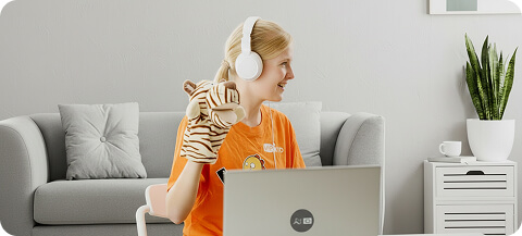 Online English teacher with a headset and puppet preparing a lesson