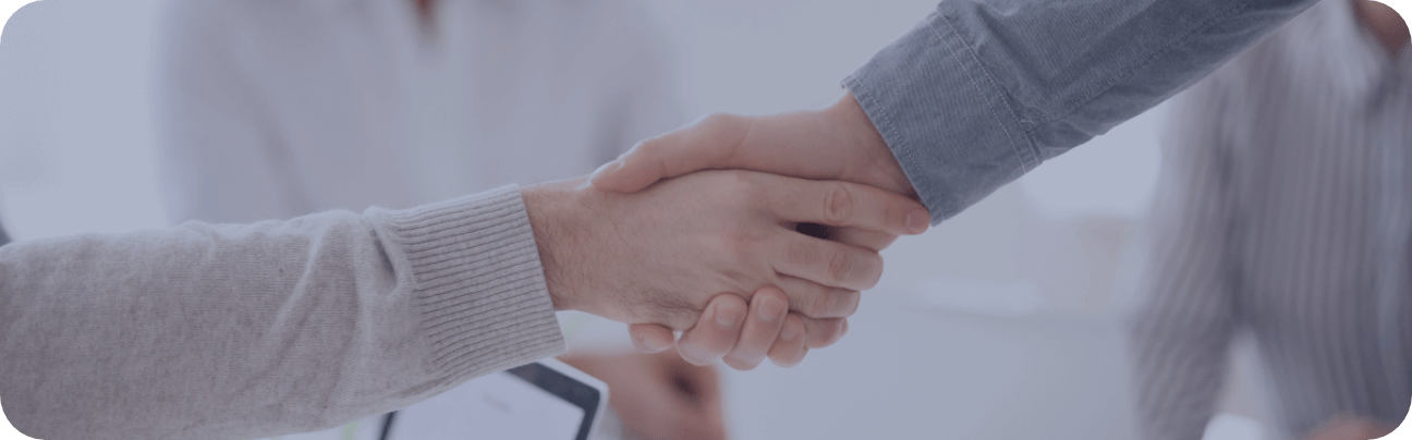 A close-up image of two people shaking hands