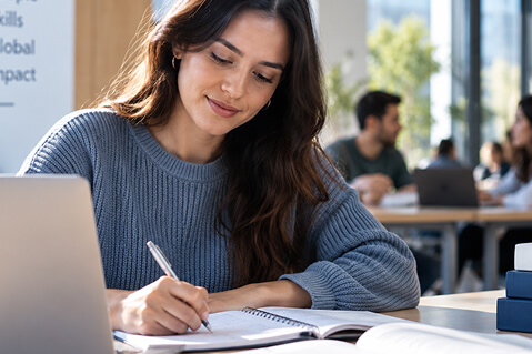 Teacher trainee studying and writing notes