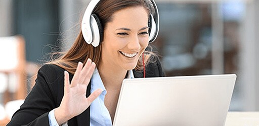 Online teacher waving during a live virtual class